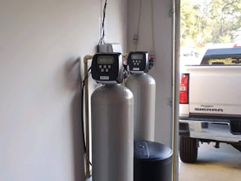 Whole house water treatment system in garage. Water softener and carbon filter.